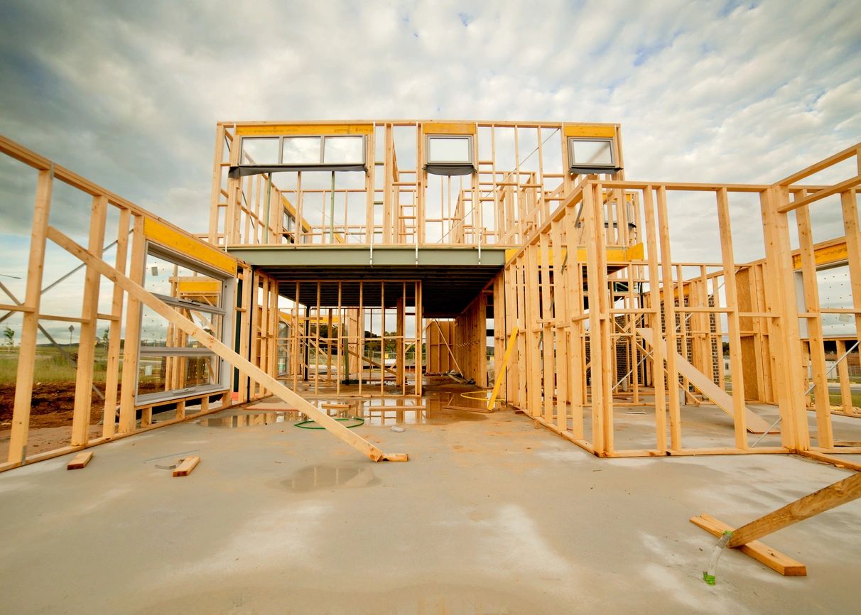 A building under construction with stairs going up the side.